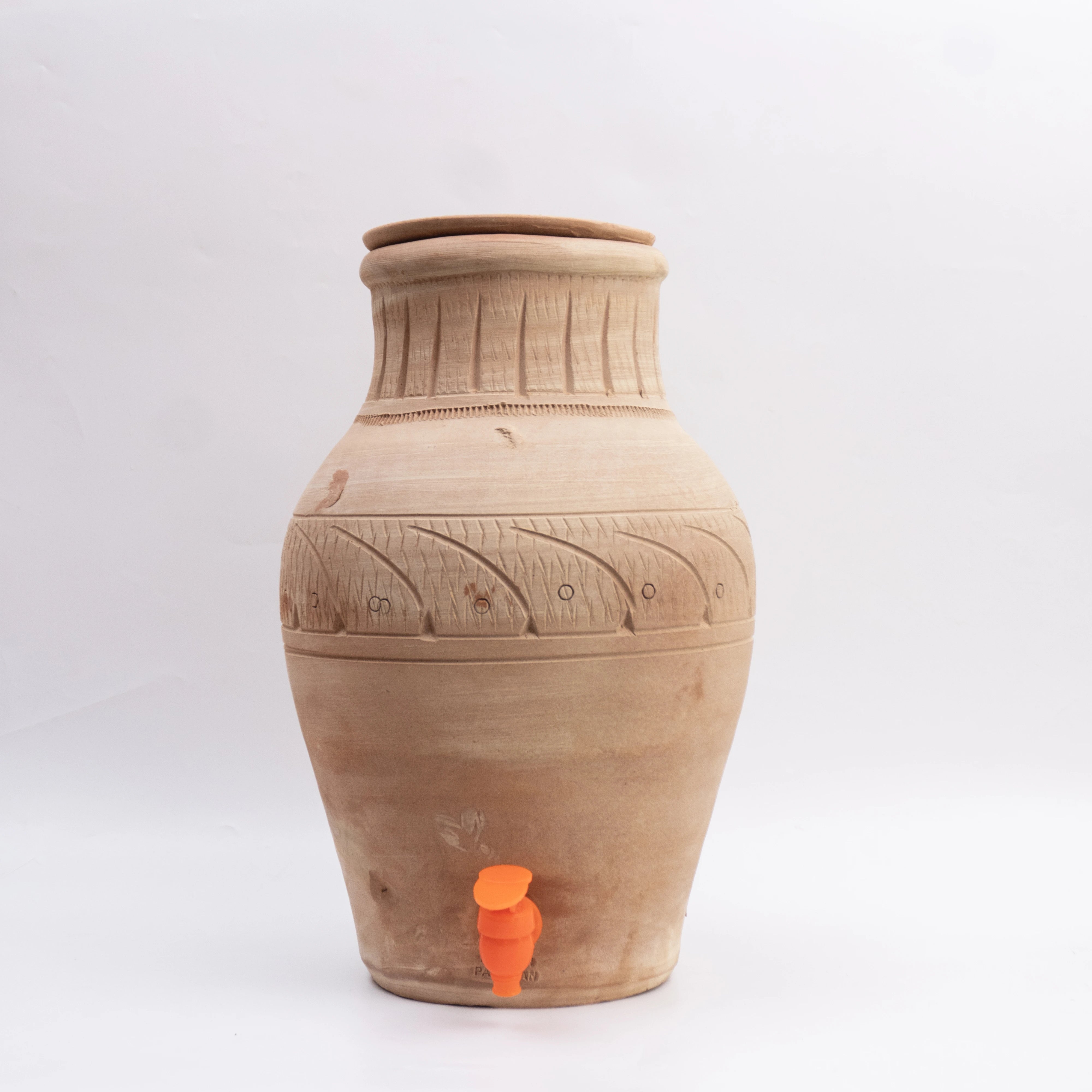 Terracotta water dispenser with decorative patterns on a white background