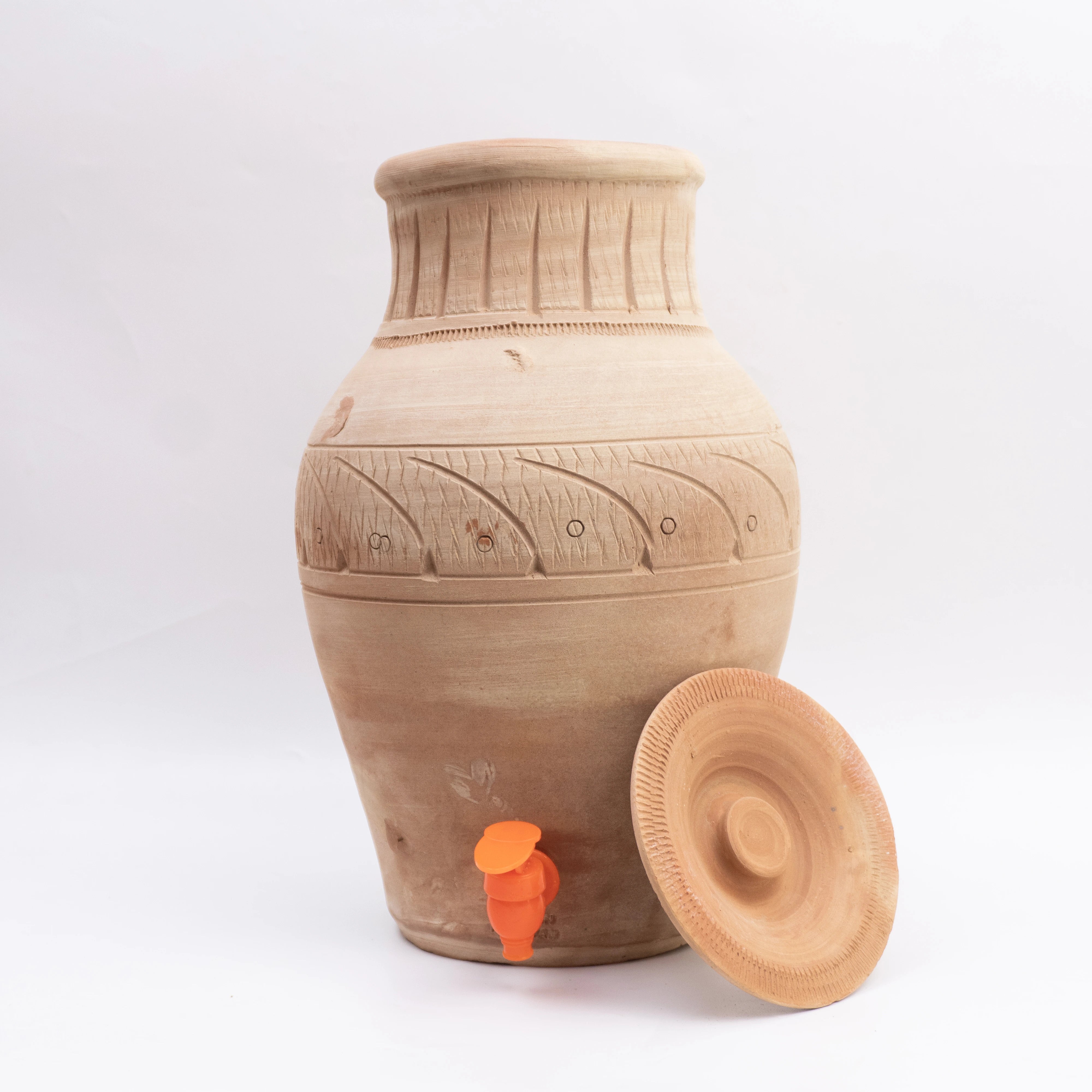 Terracotta jar with lid on a white background