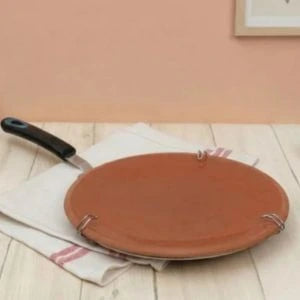 Round griddle with handle on a wooden floor