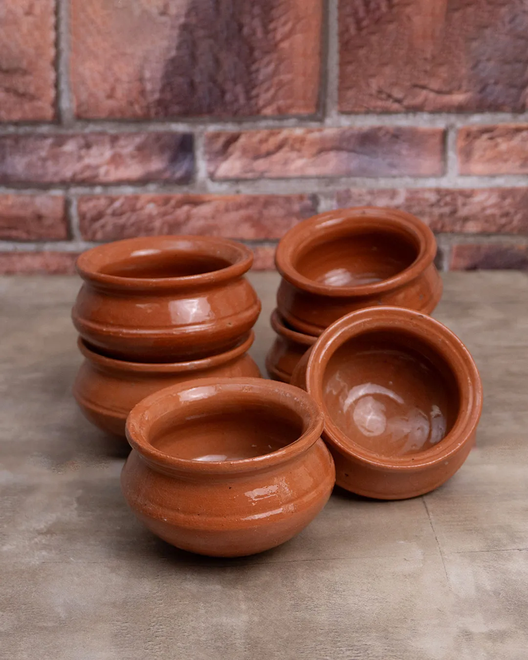 Set of six handcrafted clay mini handis with glossy finish, ideal for serving or décor.
